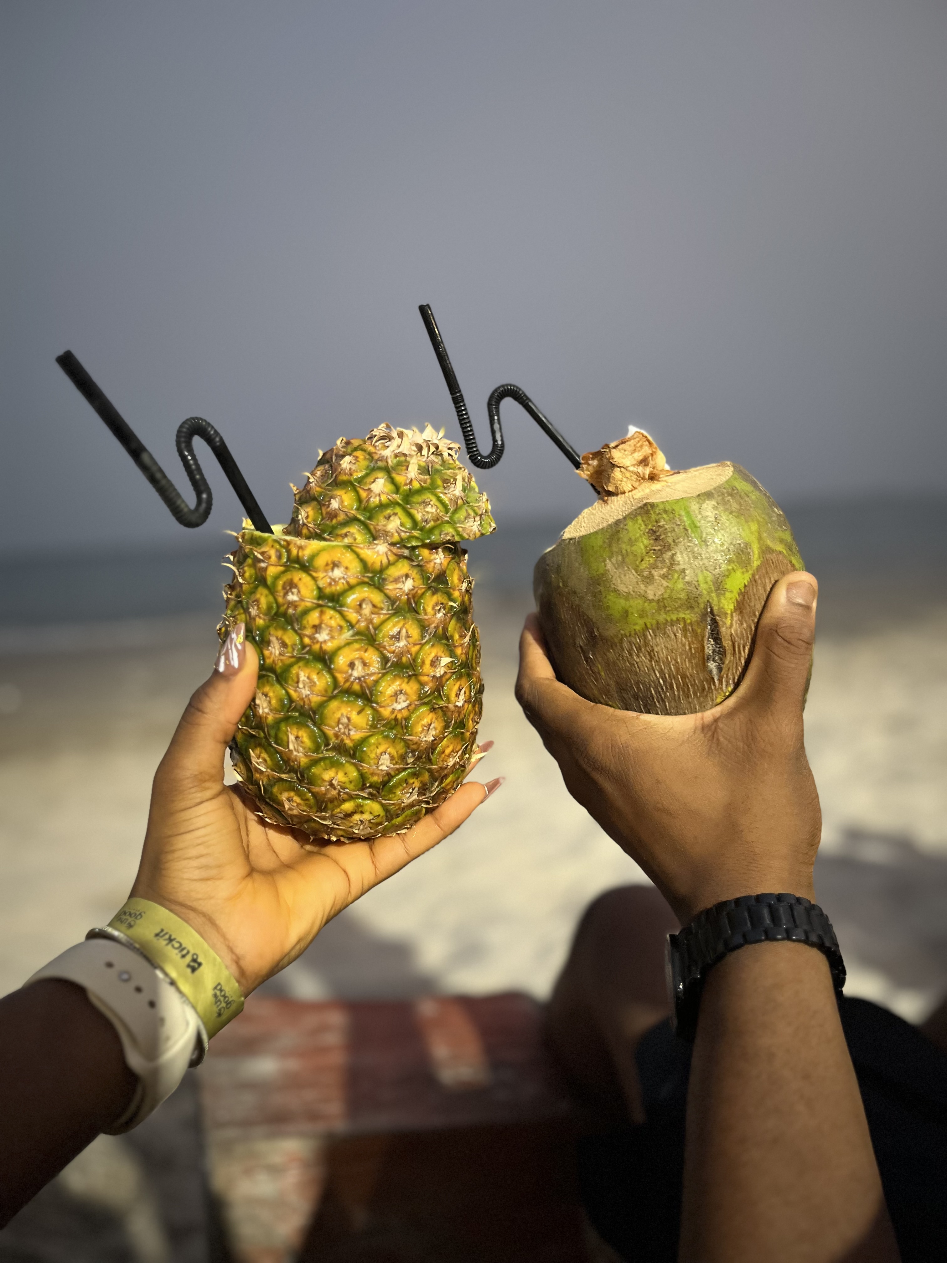 Coconut and pineapple on a beach